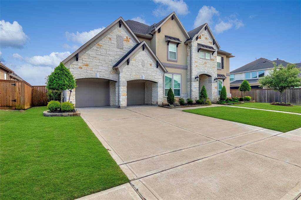 Three car tandem garage with epoxy flooring. Extended width of driveway.