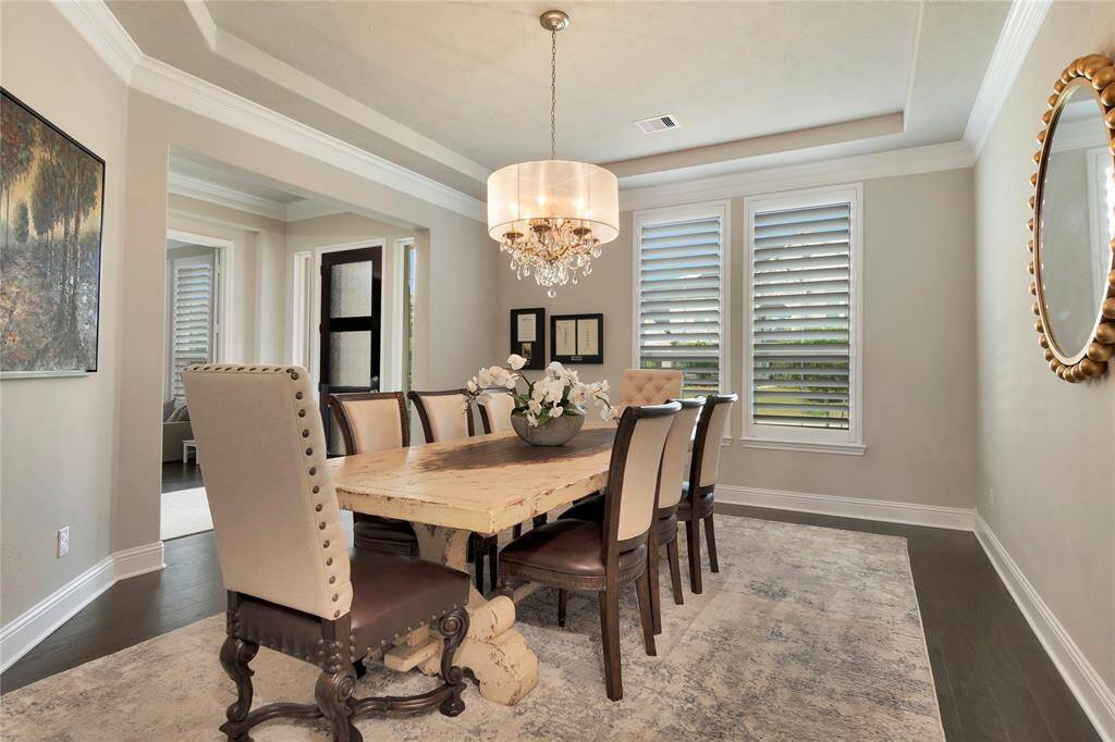 Dining to your left at entry, tray ceilings, crown molding, beautiful chandelier.