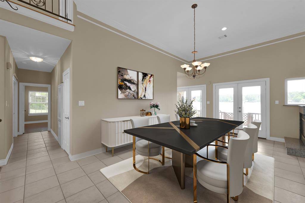 The dining area over looks large windows showcasing Lake Conroe