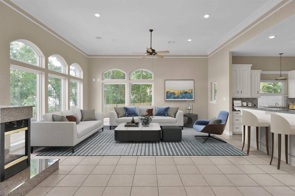 The large living room with oversized windows showcasing Lake Conroe