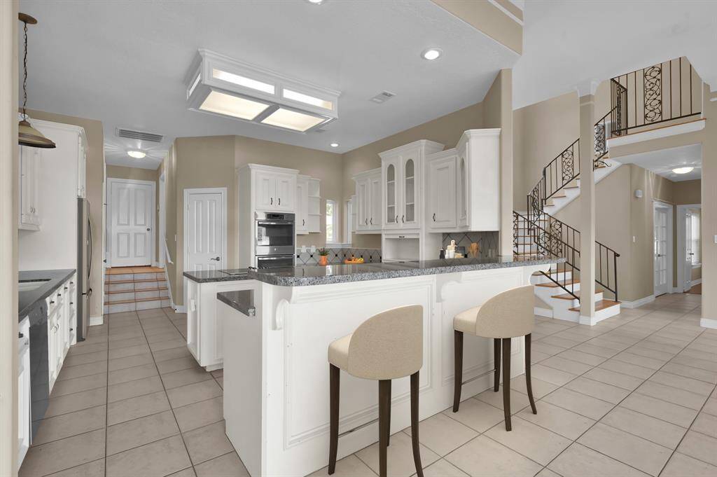 Large chefs kitchen with barstool seating