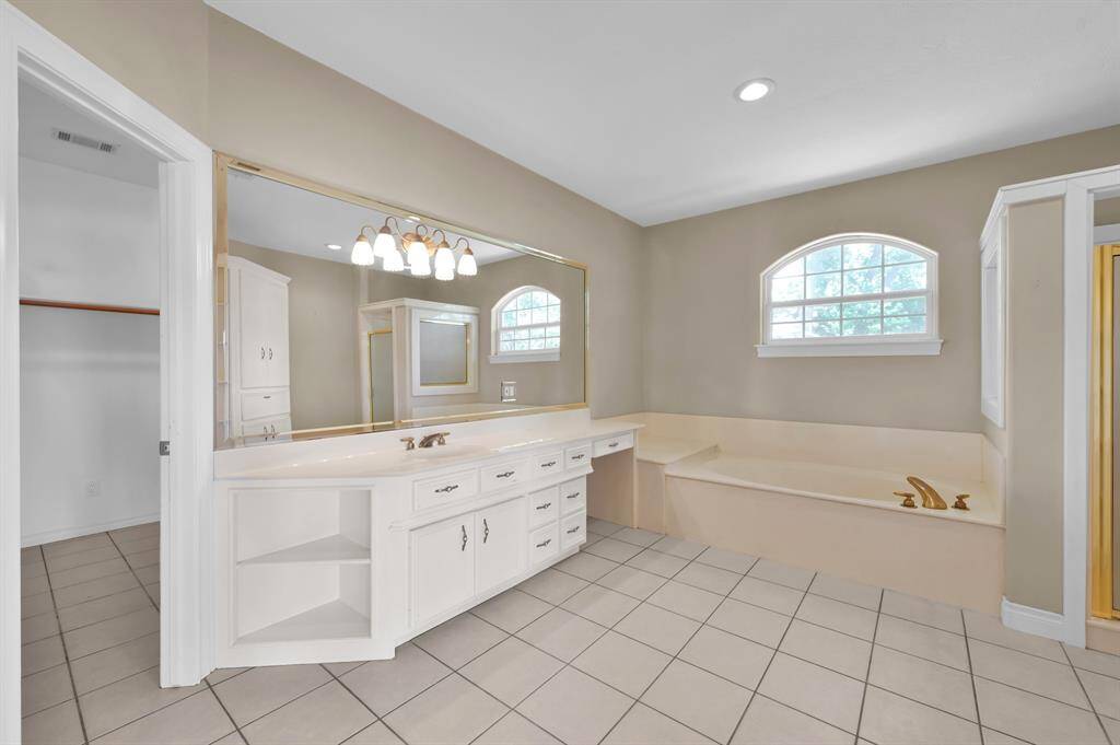 Primary bathroom with separate soaking tub and walk in shower.