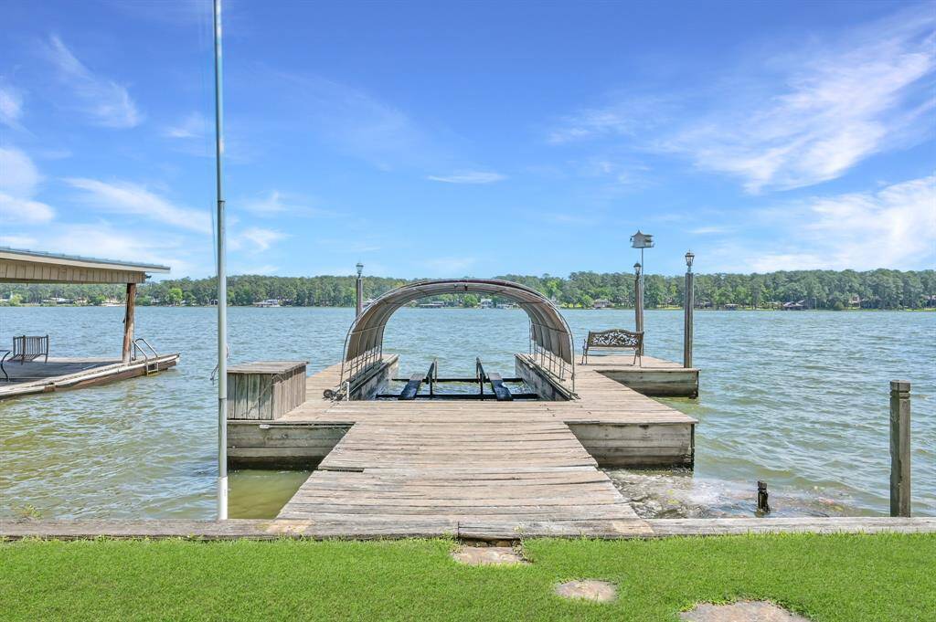 Private covered boat dock with slip and sitting area.