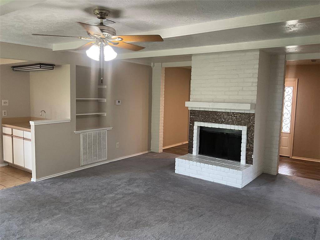 Inviting living room with cozy fireplace and direct view of the front entrance.
