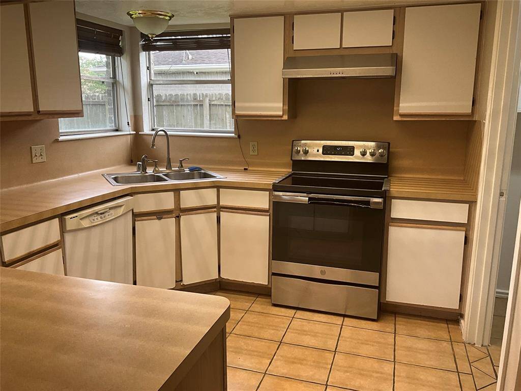 Spacious kitchen with abundant natural light, modern appliances, and ample counter space for all your culinary needs.