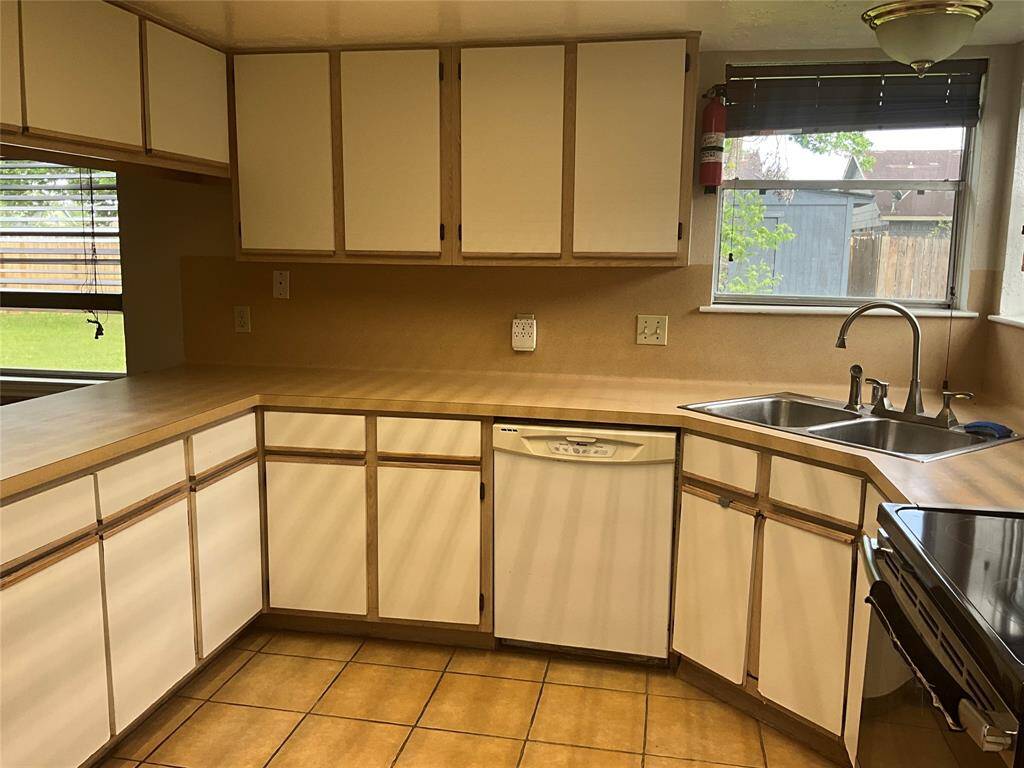 Spacious kitchen with ample cabinetry, a modern sink, and natural light. Perfect for culinary creativity and family gatherings.