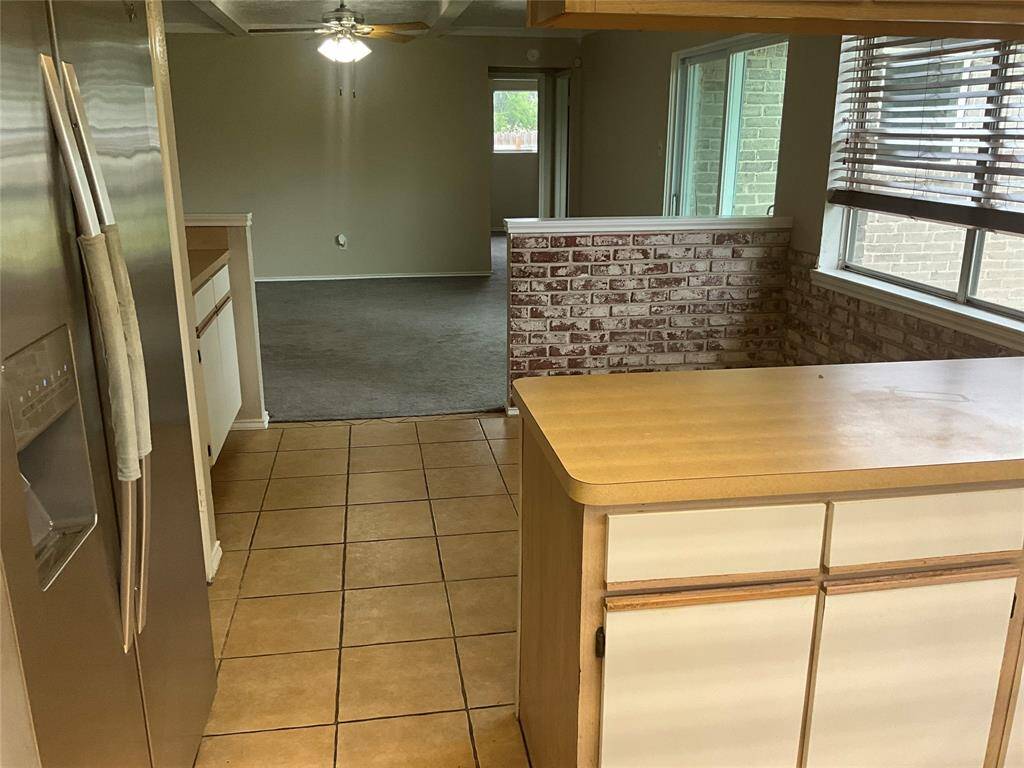 Bright kitchen with seamless flow into the breakfast area and living room, perfect for entertaining.
