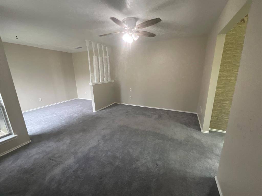 Spacious primary bedroom with soft carpet, neutral tones, and ample natural light—perfect for relaxation and comfort.