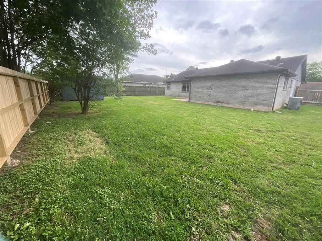 Spacious backyard with brand-new fencing for privacy and security.