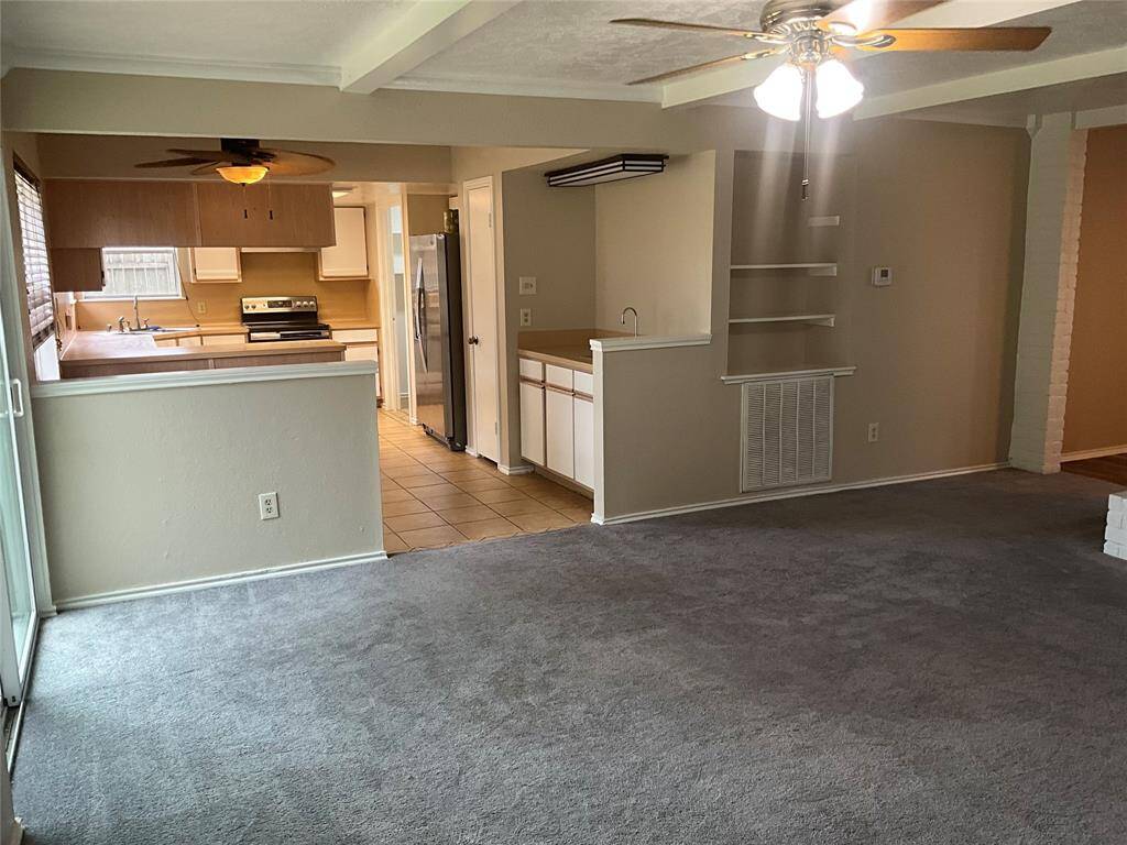 Spacious living room seamlessly flows into the bright kitchen and cozy breakfast area.