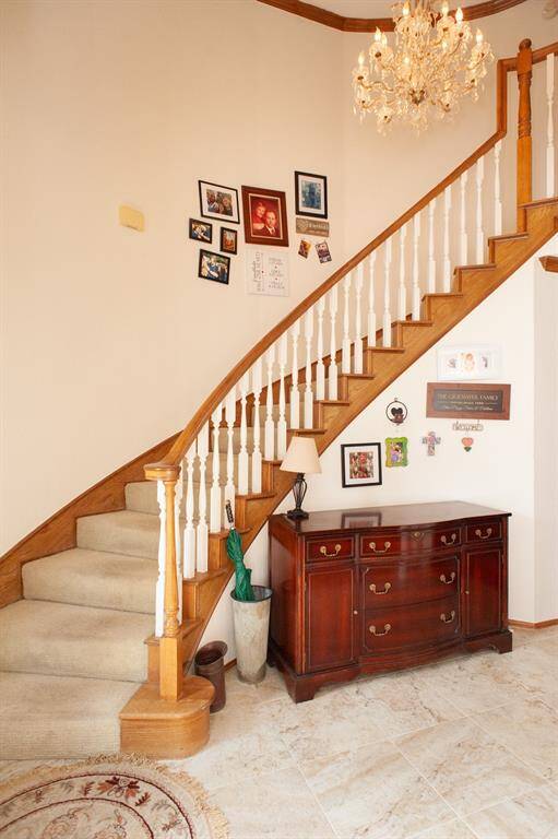 Stairway leading upstairs to game room and two bedrooms.