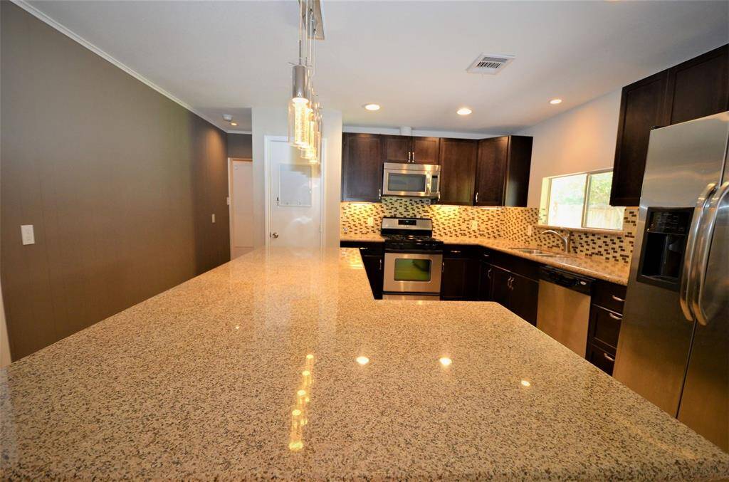 Expansive granite countertops, great for entertaining.