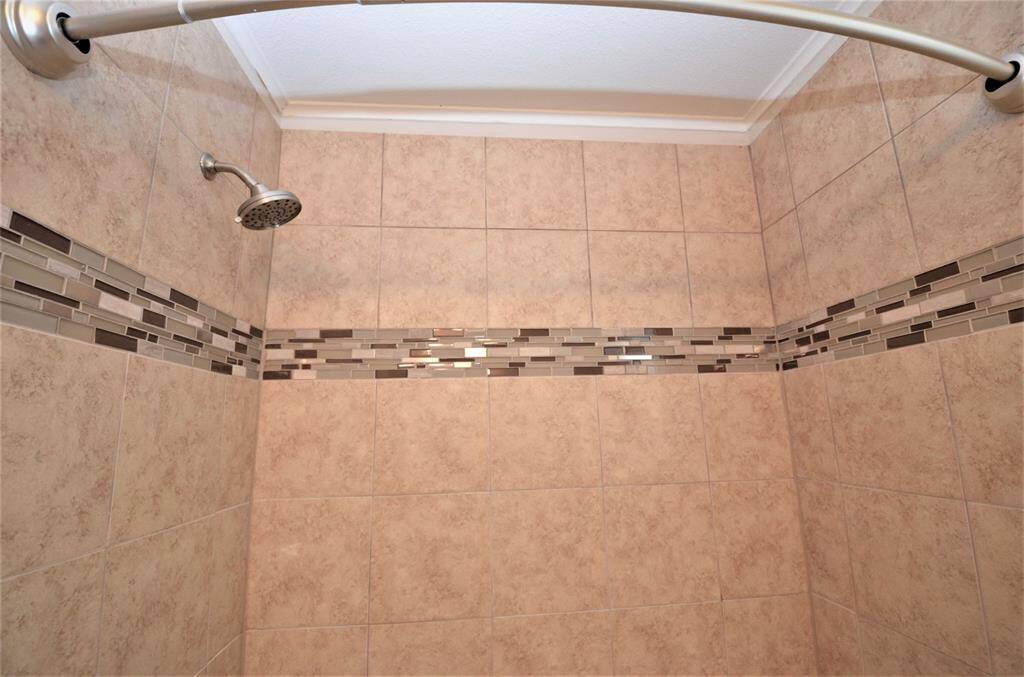 Decorative tile in shower wall.
