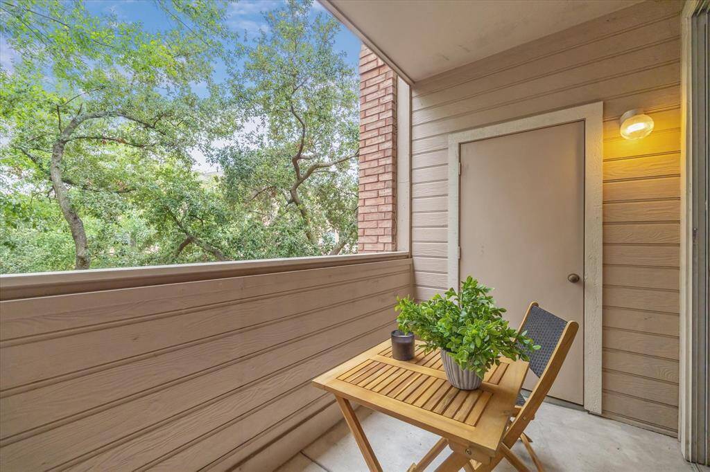 great terrace with a view of trees and a storage closet!