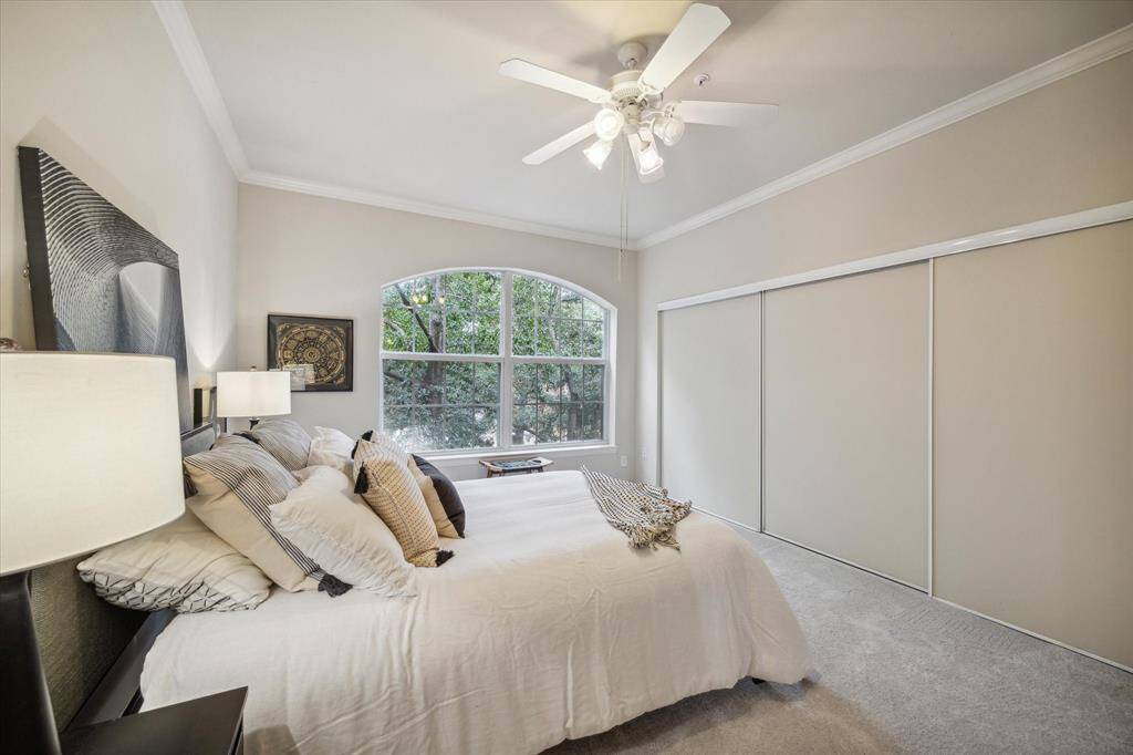 Bedroom is bright and includes a wall of closets