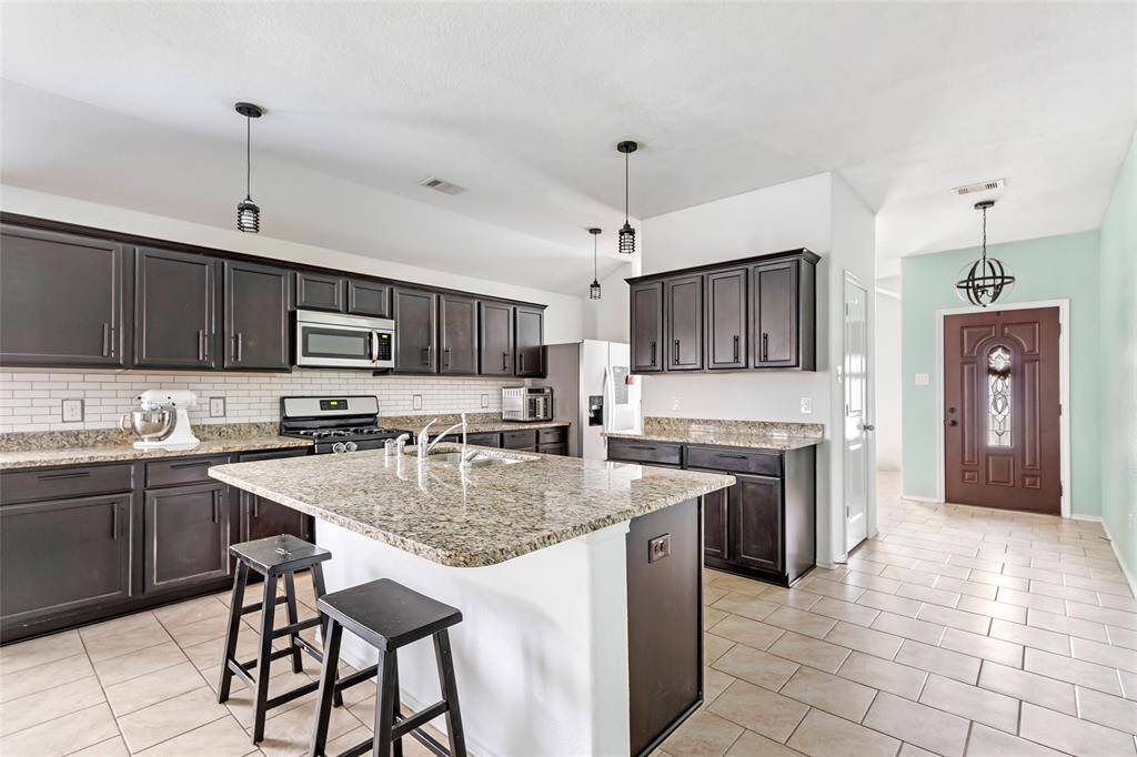 This image shows the kitchen featuring a large island.