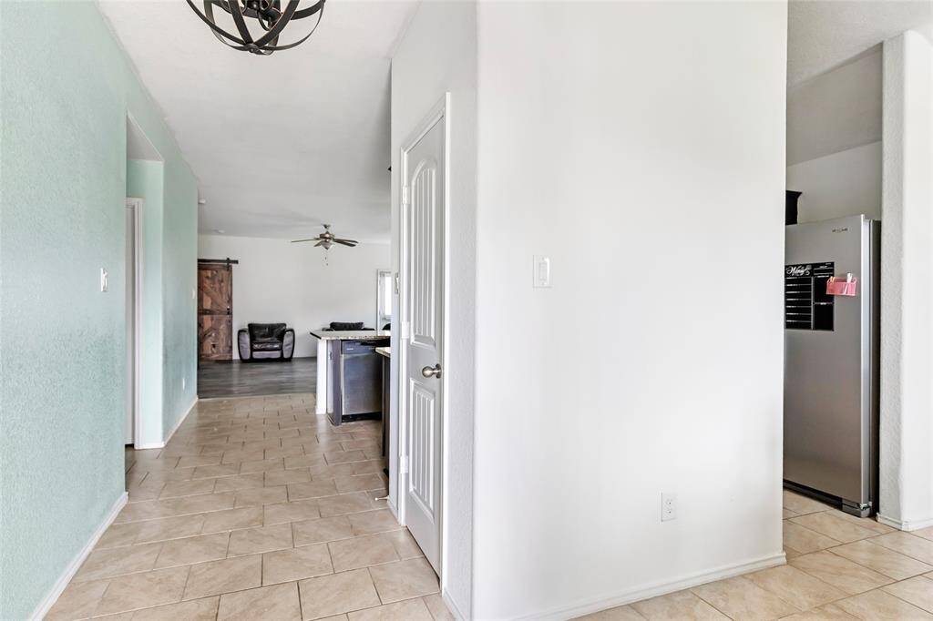 Just inside the front door, the dining room is on the right, with access to the kitchen. And you can see all the way thru to the living room.