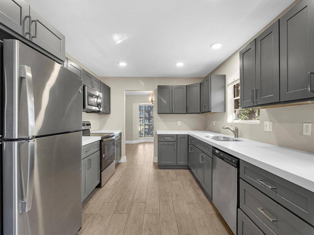 The updated kitchen boasts new cabinets, stainless steel appliances and quartz countertops.