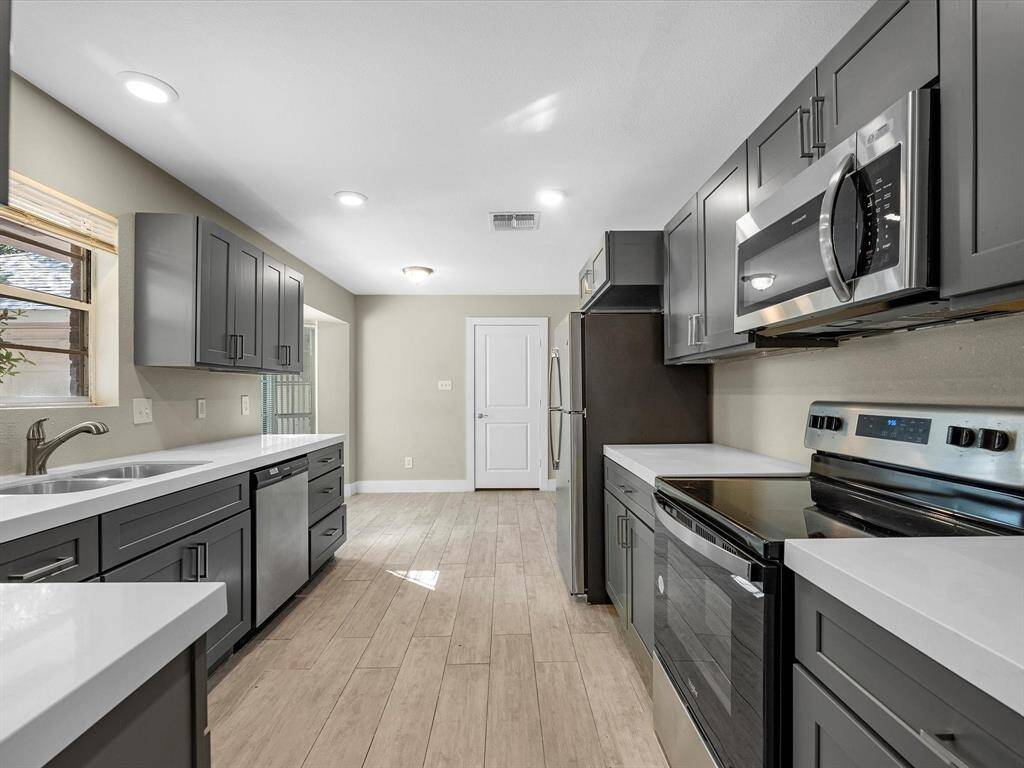 Wood flooring and recessed lighting enhance the updated, modern look.