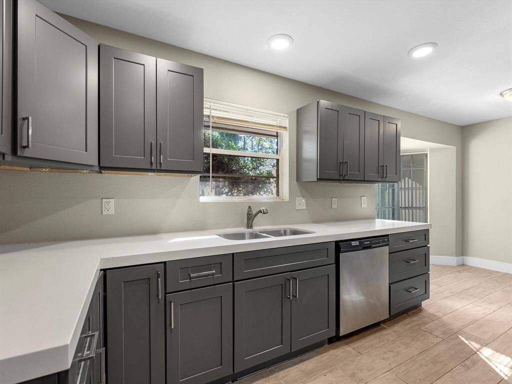 The kitchen offers ample counter space and overlooks the side driveway.