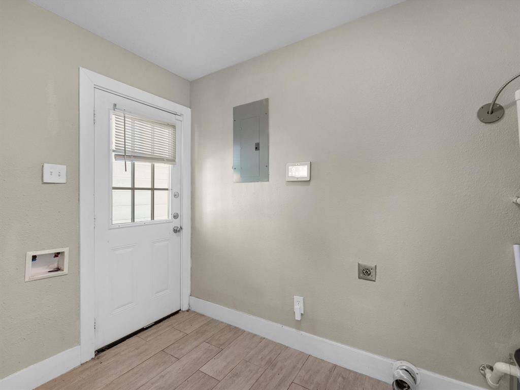 The laundry room is located at the back entrance of the home, leading directly into the kitchen.