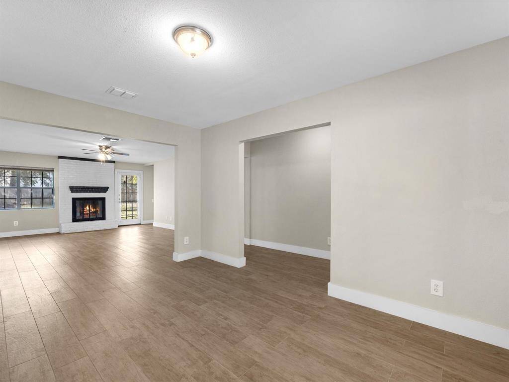 Upon entry, you are greeted by a formal living room or flex space.