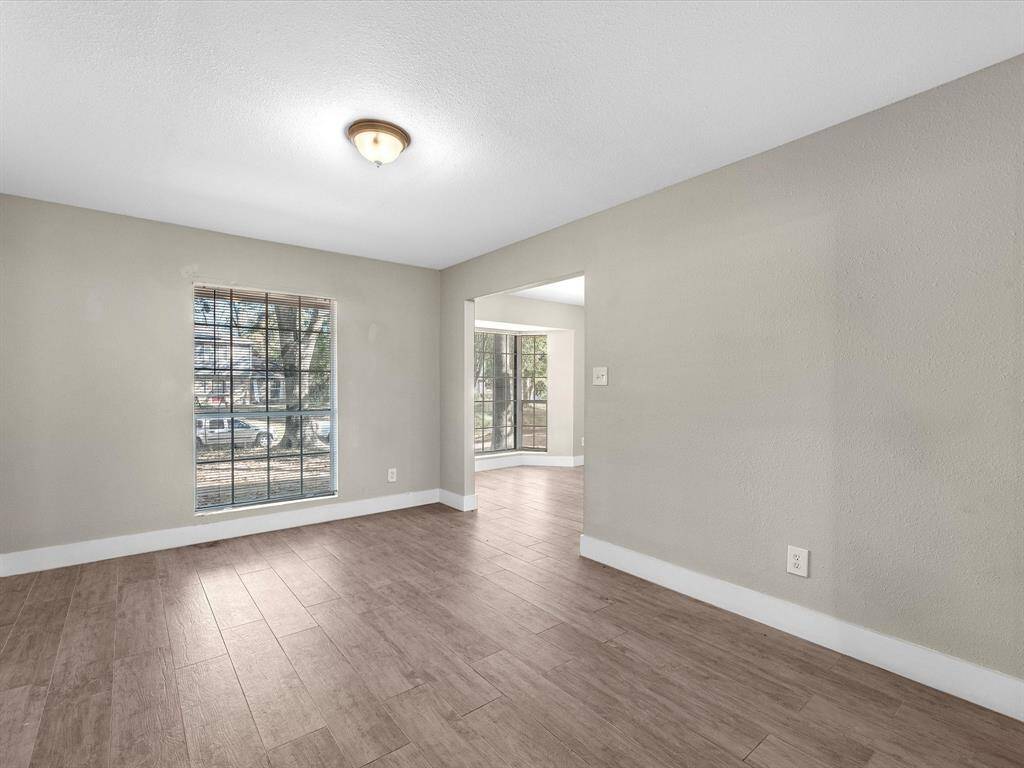 The formal living room or flex space flows seamlessly into the formal dining area.