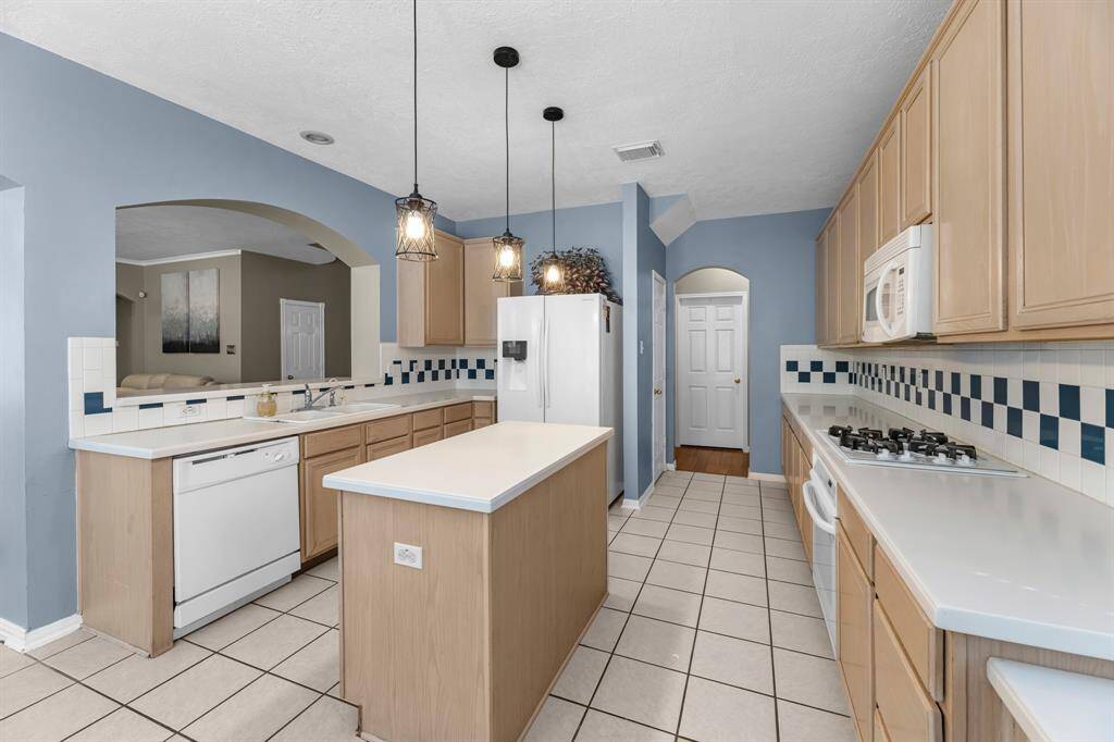 Experience the heart of your new home in this inviting kitchen, featuring modern appliances, ample counter space, and a cozy atmosphere perfect for gatherings.
