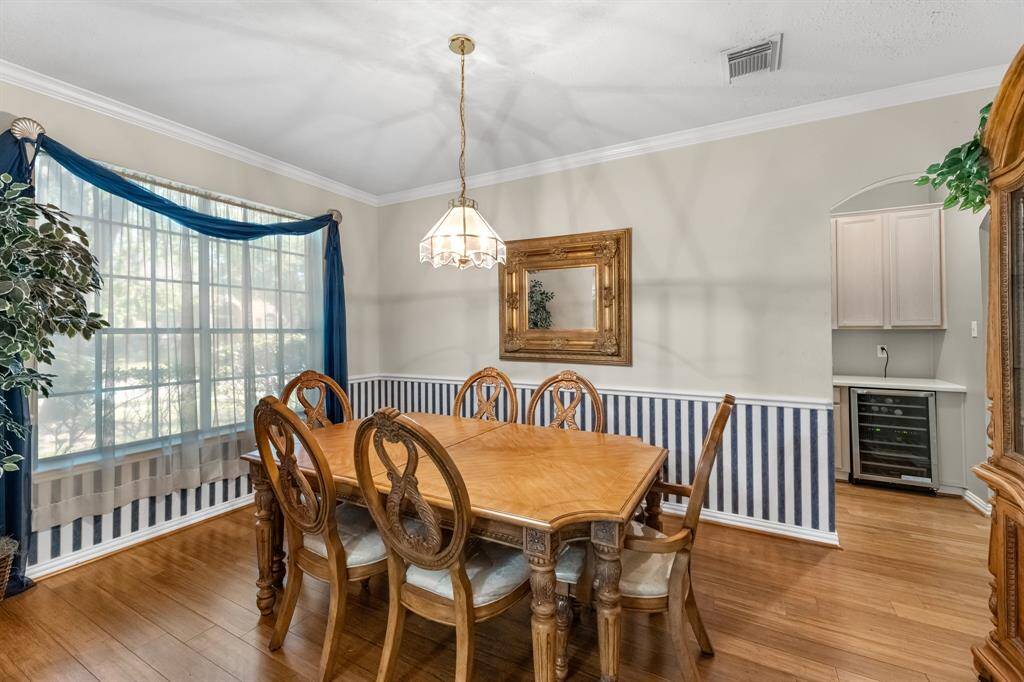 Welcome to your elegant dining space, perfect for hosting intimate dinners. Featuring abundant natural light, stylish wainscoting, and a cozy atmosphere, this room invites warmth and connection.