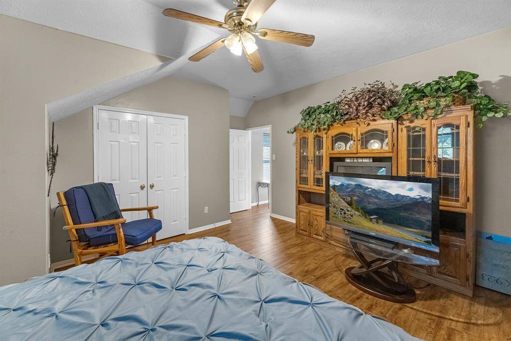 Experience comfort in this cozy, inviting room with warm wood floors, ample closet space, and a stylish entertainment center.