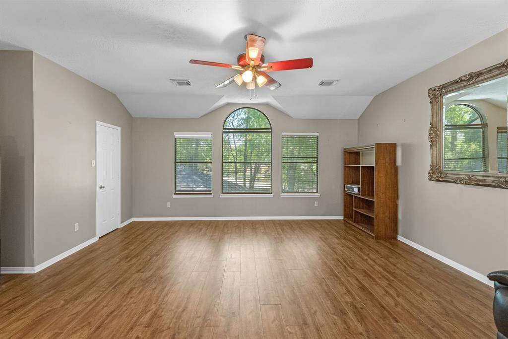 Imagine your life in this spacious, light-filled room with elegant hardwood floors and large windows offering serene views. Perfect for creating your dream living space.