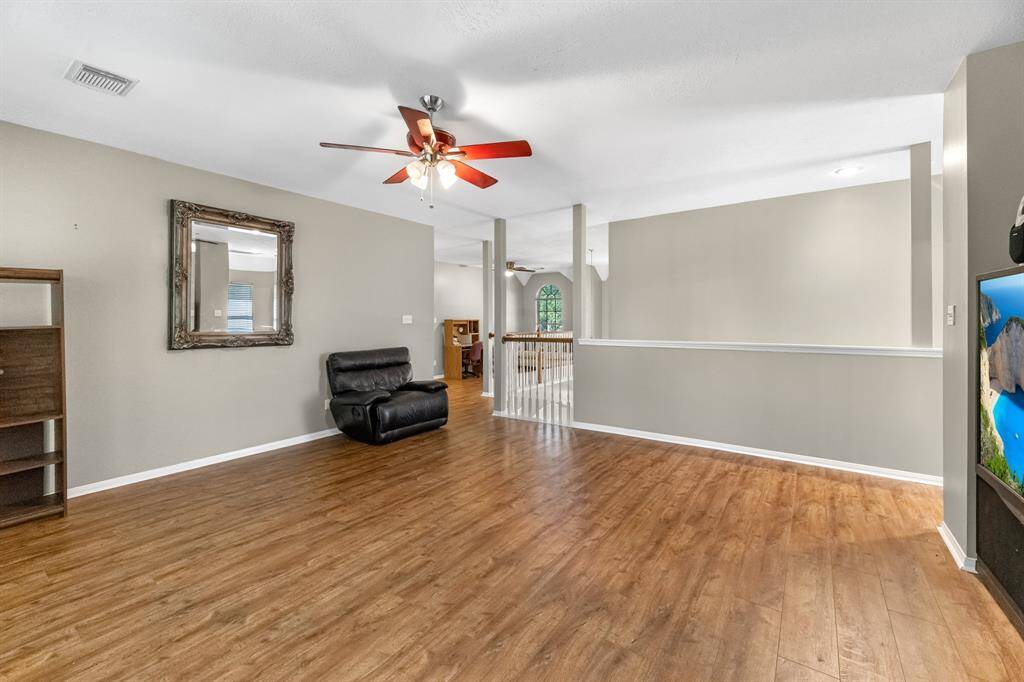 Imagine relaxing in this spacious, inviting room with elegant wood floors and abundant natural light. Perfect for creating your dream living space.
