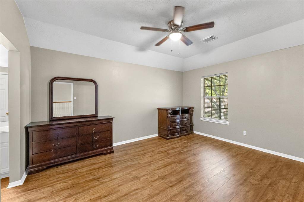 Imagine relaxing in this bright, spacious room with elegant flooring and a stylish ceiling fan, perfect for creating your dream retreat.