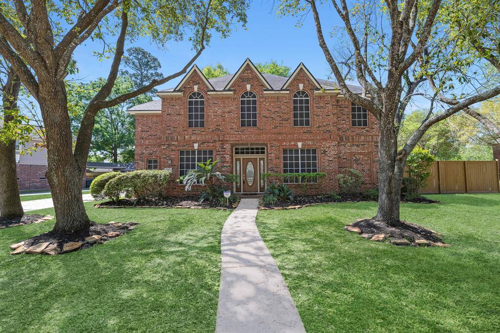 Welcome to your dream home! This stunning brick house offers timeless elegance, nestled among mature trees and lush landscaping. Imagine relaxing in this serene, inviting setting.