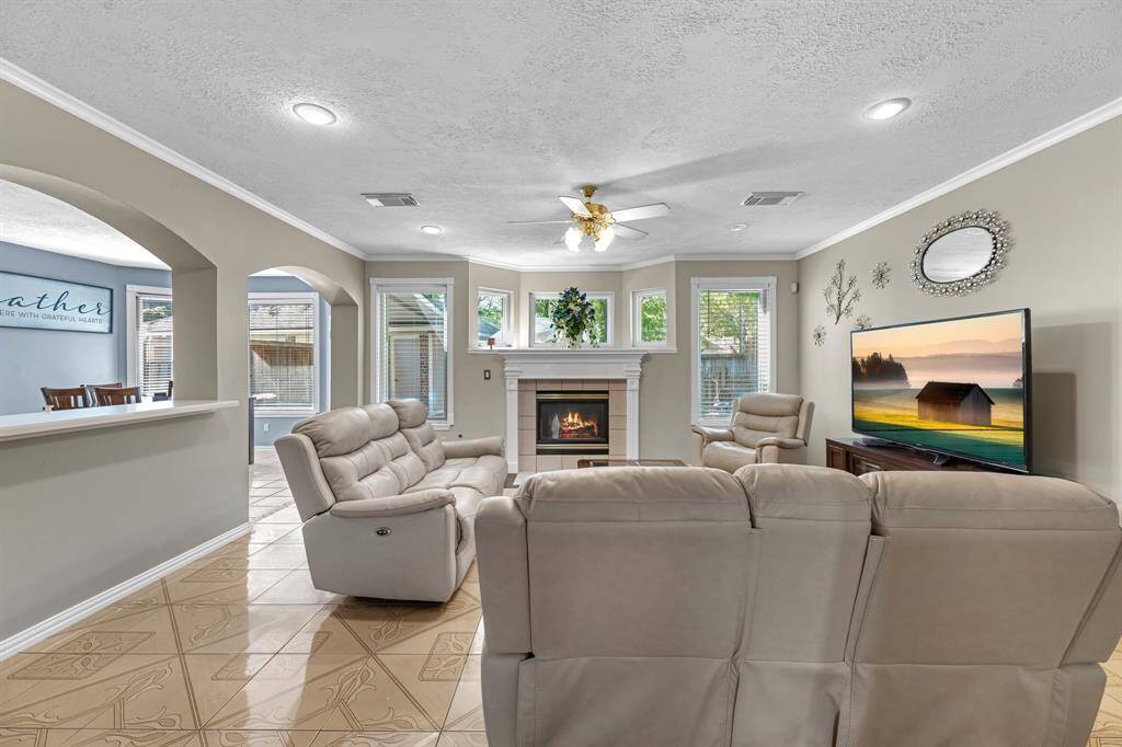 Welcome to your cozy retreat, featuring a warm fireplace, elegant arches, and abundant natural light. Perfect for relaxed living and entertaining.