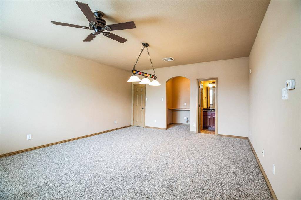 Upstairs game room with desk, closet, and half bathroom.