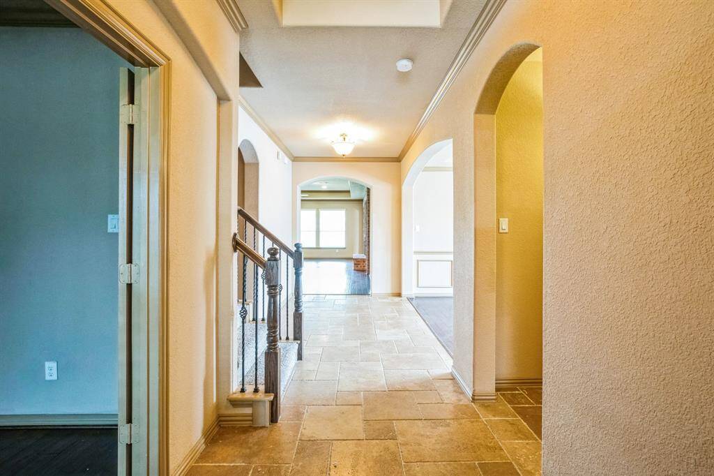 Entry with office, stairs, and secondary hallway to the left and  4th bedroom with bath to the right.