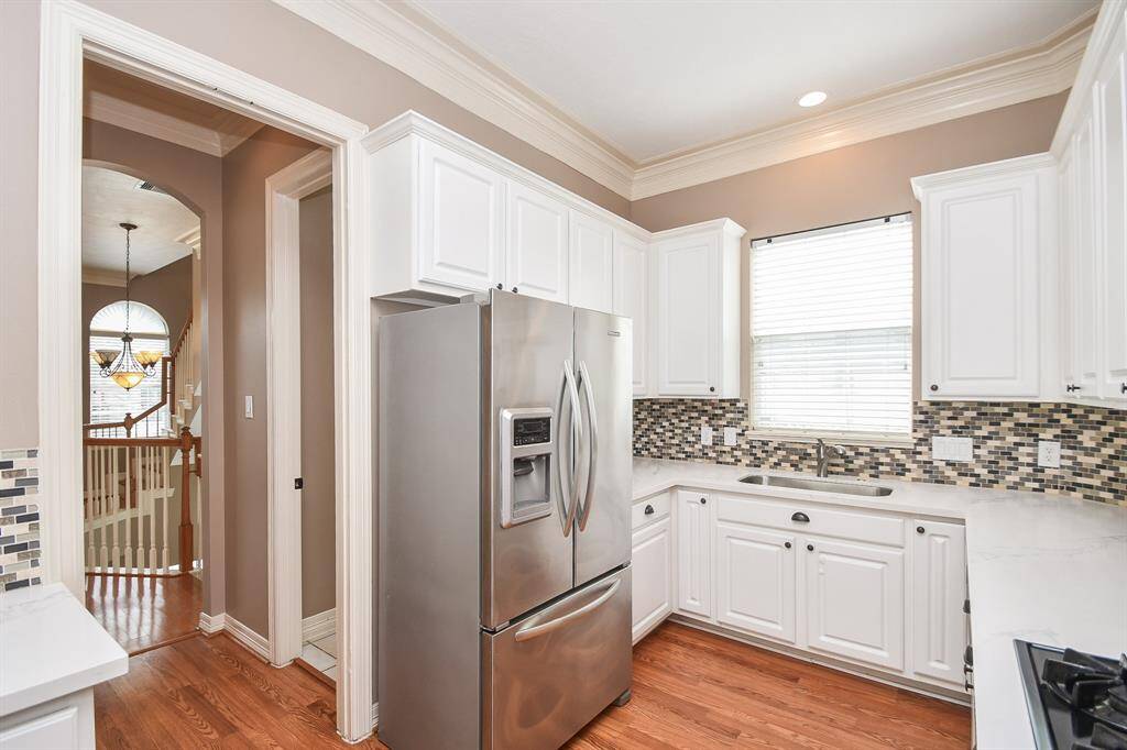 This kitchen is accessible to and from common areas on this amazing level.