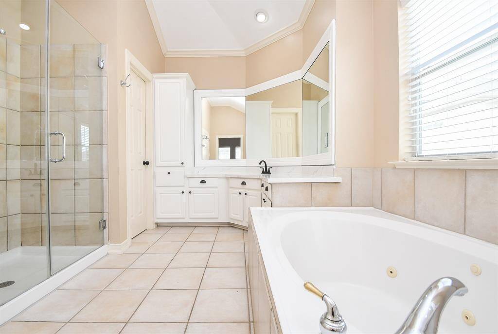 There's just something so soothing about a primarily white bathroom (or kitchen, for that matter), like this bright, spotless primary ensuite bath.