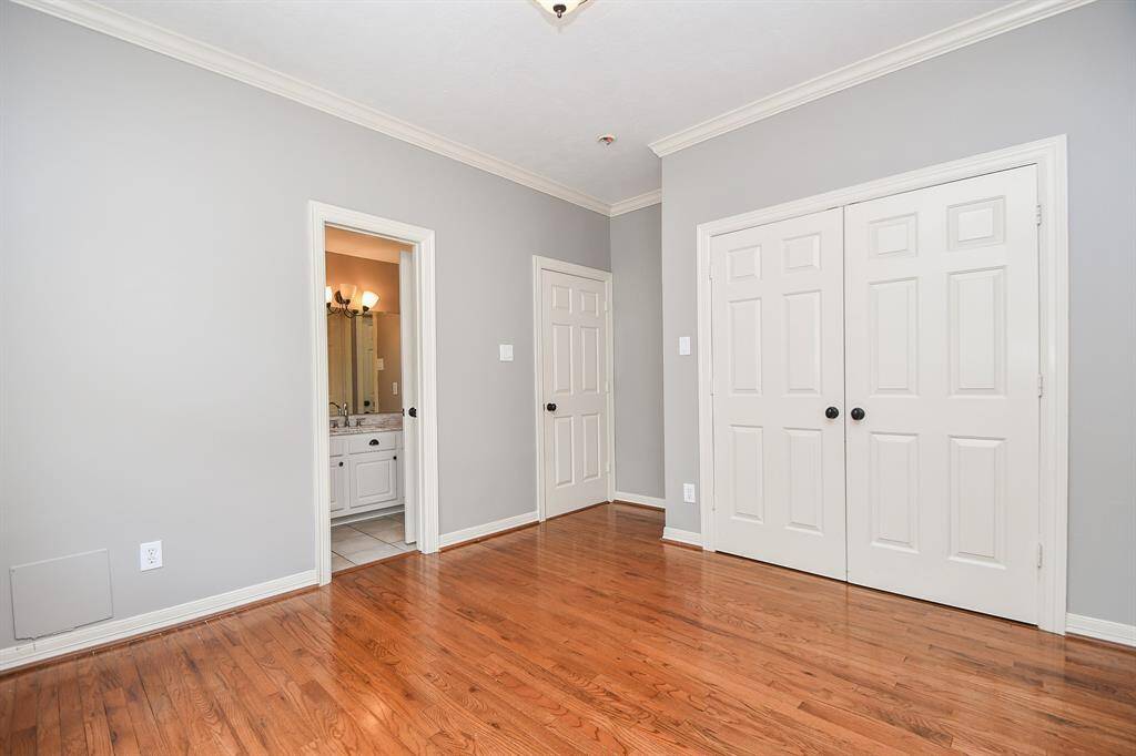An ensuite bath peeks out, left, in this secondary bedroom.