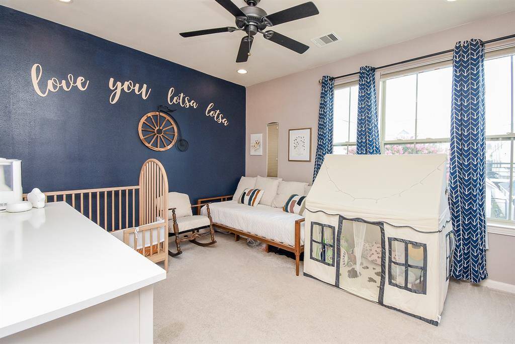 A carpeted secondary bedroom can be many things, as suggested here.