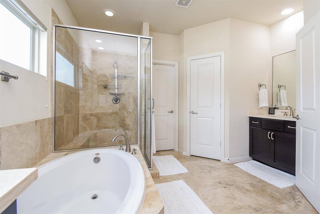 It only takes a bit of white tones, contrasted with dark accents (cabinetry) to make your stunning primary ensuite bath a visual and sensual retreat.