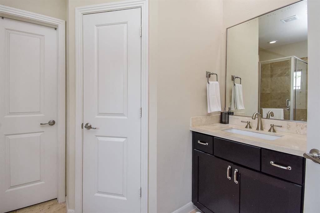 The trend today, seems to be favoring light (white) primary surfaces in baths and kitchens—which is surely comforting. (The same applies to ensuite baths)  Cool off-white walls frame this comfortable bathroom, with dark chocolate colored cabinetry.