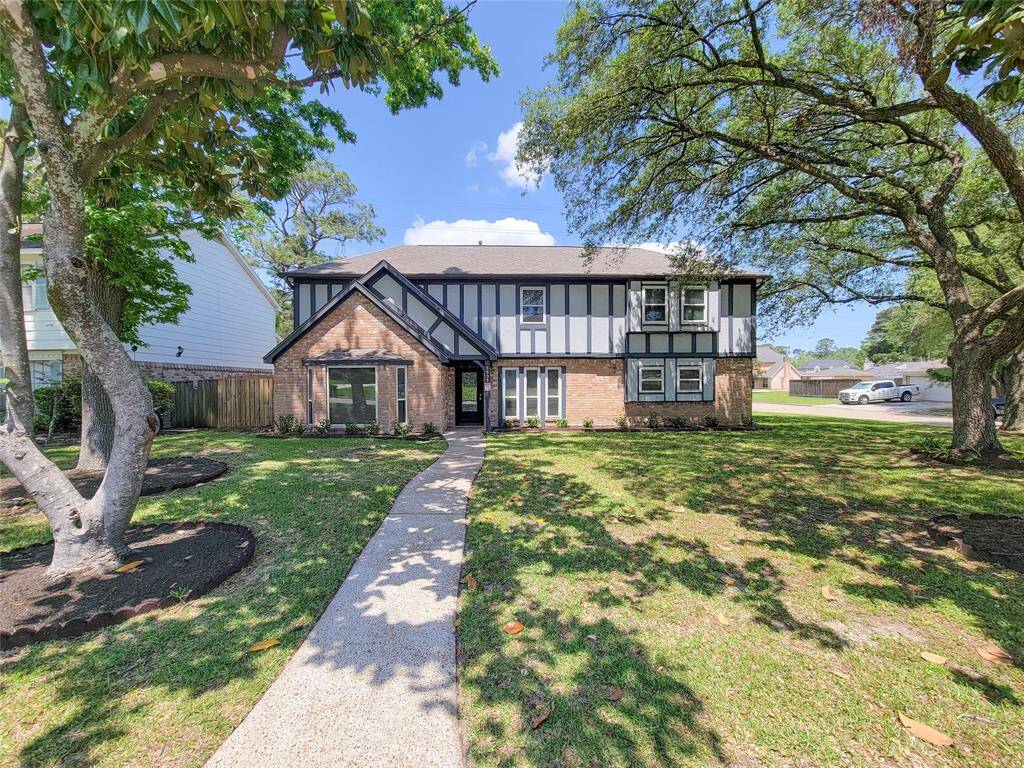 A welcoming first impression—lush trees and curb appeal that feels like home