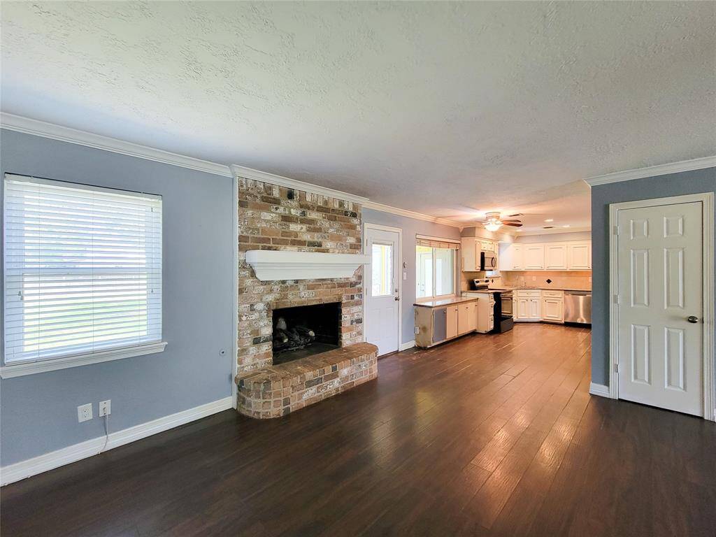 Charming brick fireplace with a sleek white mantel, perfect for cozy nights and adding character to the room.