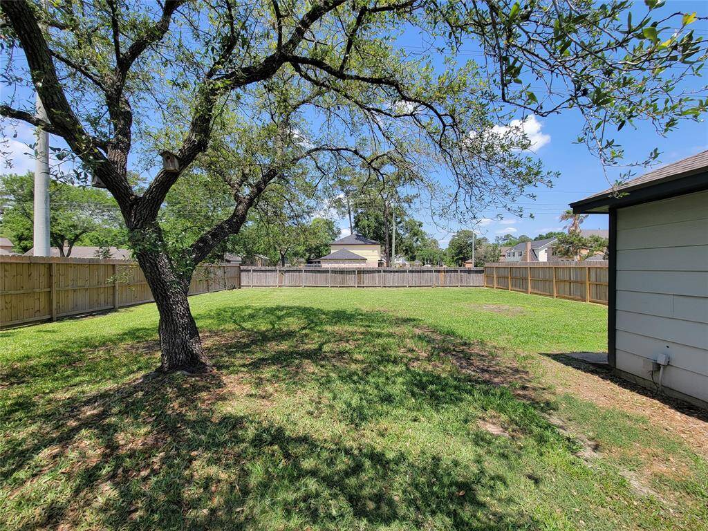 A charming tree in the backyard provides natural shade, creating a cozy and inviting outdoor space