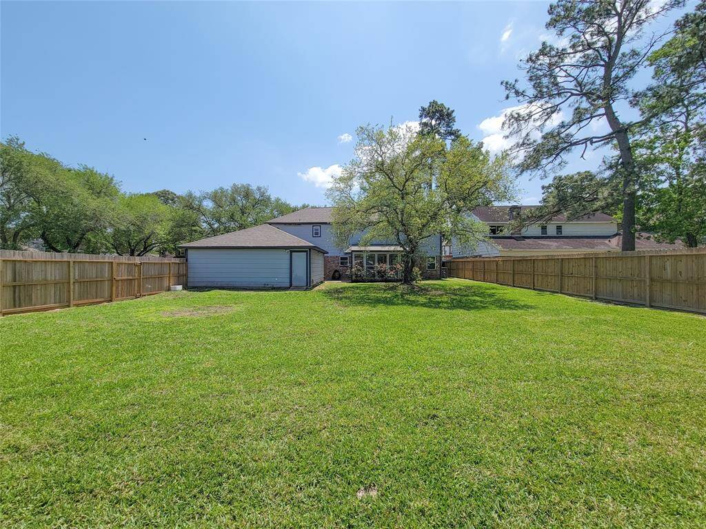 This expansive backyard offers plenty of room for play, relaxation, and creating your outdoor oasis