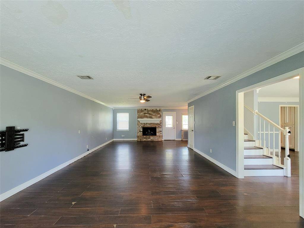 Cozy up by the charming brick fireplace in this spacious family room, perfect for movie nights, game days, and everything in between
