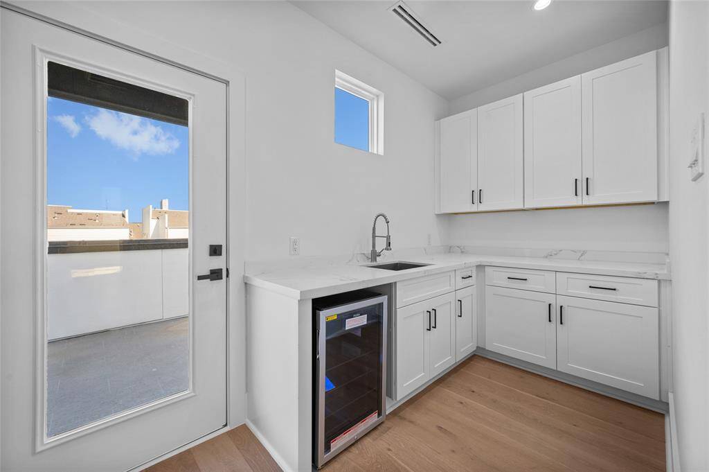 View of wet bar area with beverage fridge by Game Room from similar plan