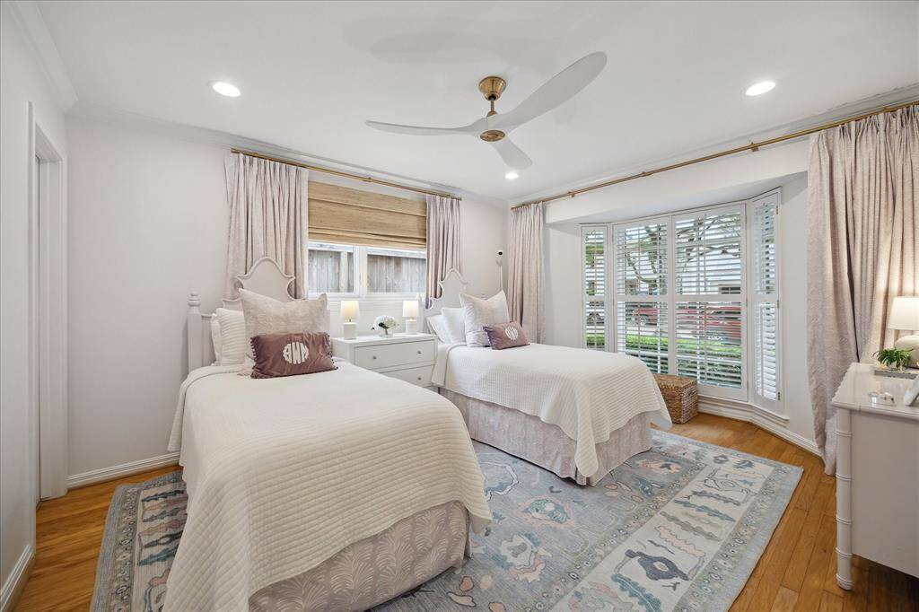 This secondary bedroom is located at the front of the home and includes a large walk-in closet (not pictured), a door to the hall bathroom, and ample windows and natural light!